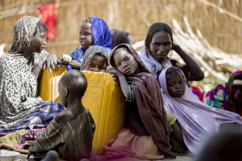 Chadian children with their mothers in a displacement camp  