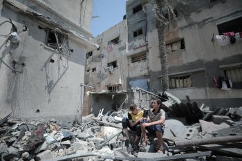 Teenagers in Gaza among shattered buildings