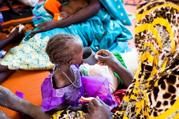 Sudanese child drinking tea