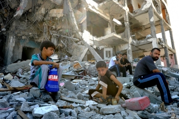 Palestinians kids after their homes were hit by Israeli attack in Gaza